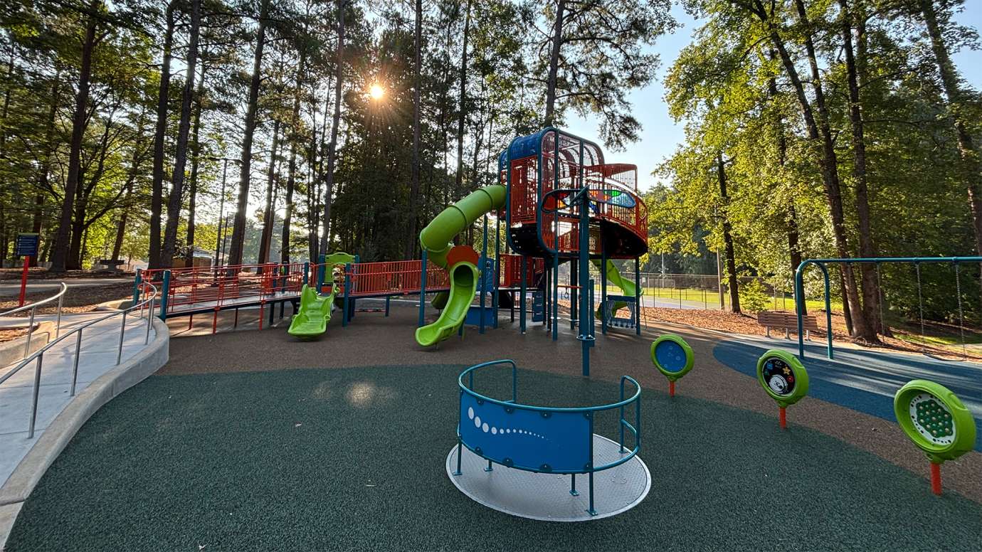an orange, blue and green playground with slides