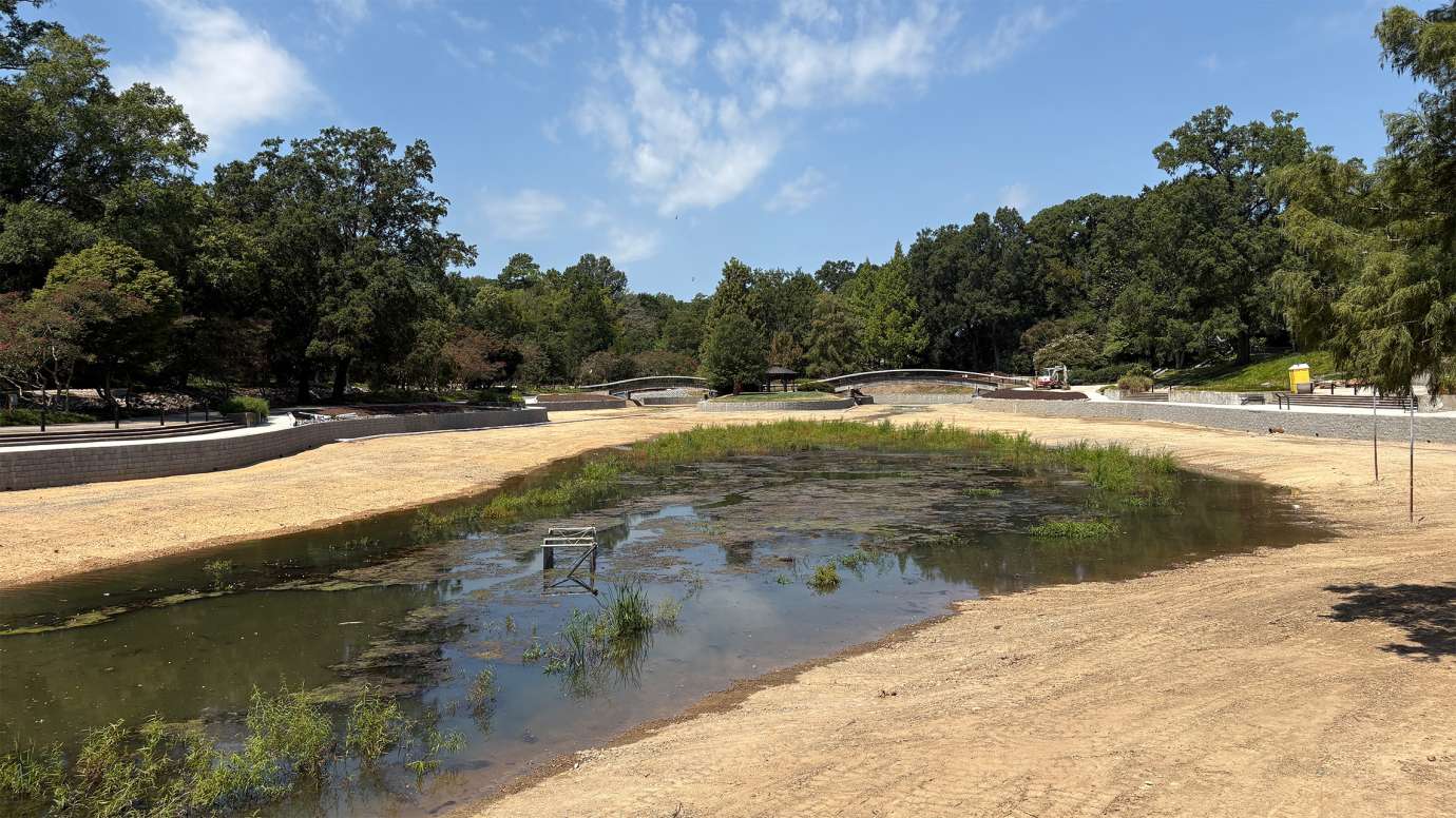 a drained lake and new retaining walls at Pullen Park