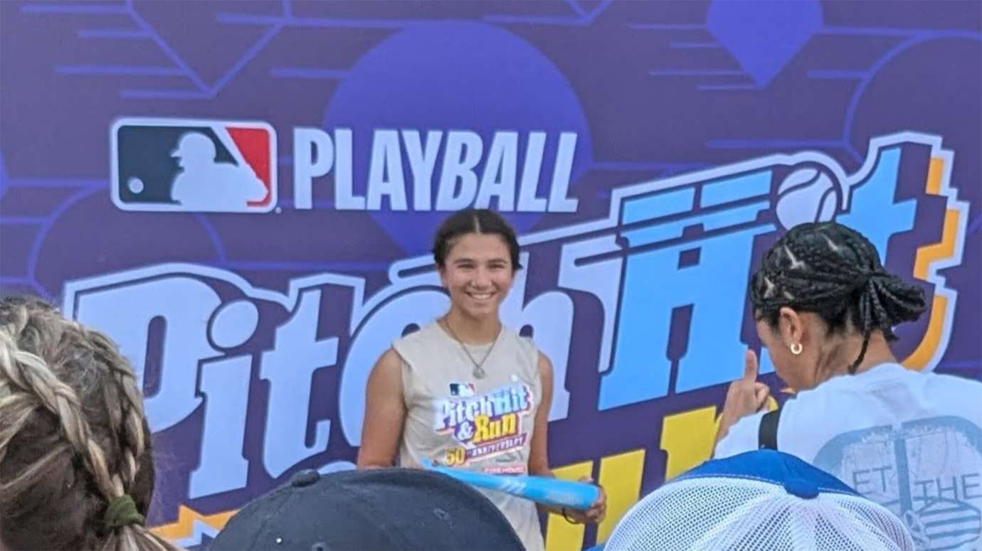 a young baseball player in front of backdrop