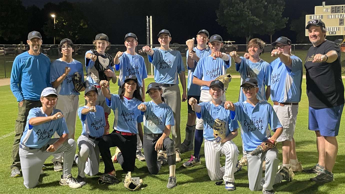 a youth baseball team wearing light blue jerseys