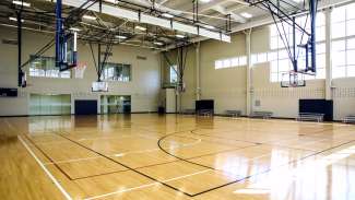 Basketball hoops set up inside the Abbotts Creek gymnasium