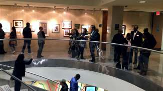 people gathered in a gallery space