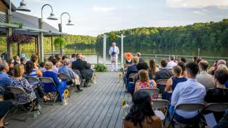 Wedding guests seated on the deck on lake johnson parks