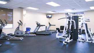 An indoor fitness room with equipment and a stretching station at Marsh Creek