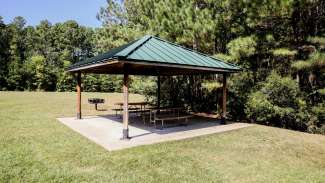 A second smaller outdoor picnic shelter with two tables at Baileywick Park