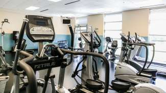 part of Barwell Road Park fitness room with treadmills, bikes, and free weights 