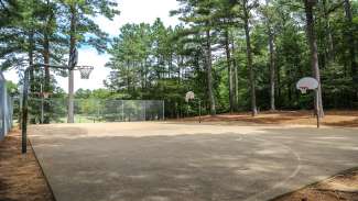 Concrete outdoor basketball court with four hoops at Biltmore Hills