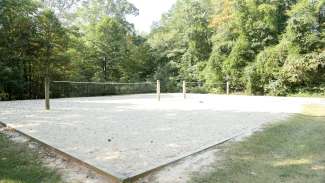 Two outdoor sand volleyball courts with nets at Carolina Pines Park