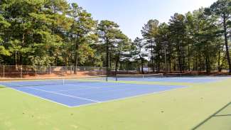 Multiple outdoor tennis courts at Carolina Pines Park.