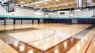 empty gymnasium at Millbrook Exchange commuity center with four hoops