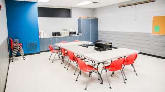 A smaller classroom at Green Road Park with chairs around a table and counterspace