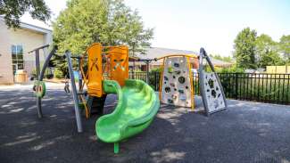 A smaller playground with a slide and climbing equipment for younger kids at Halifax Park