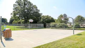 An outdoor basketball court with two basketball hoops at Halifax Park 