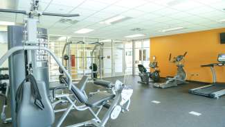 A fitness room with cardio equipment and machines at Halifax Park