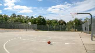 Outdoor basketball court with two hoops at Honeycutt Park 