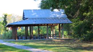 A side shot of the outdoor shelter with six picnic tables at Horseshoe Farm Nature Preserve