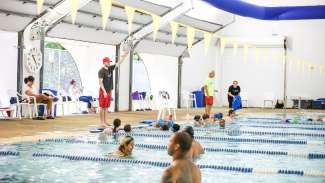 Instructor teaching a swim class at Millbrook Exchange Pool in Raleigh.