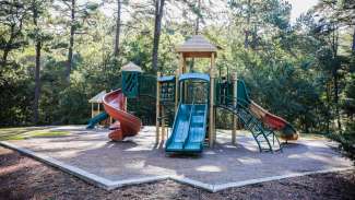 A second playground at Kentwood Park featuring two slides and a rubber surface