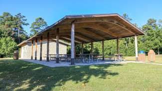 A large outdoor picnic shelter with several tables at Marsh Creek 