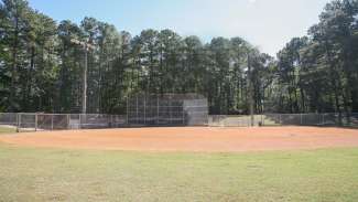 North Hills Park youth baseball field including diamond, benches and fencing. 