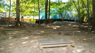 Optimist Park nature amphitheater outdoors featuring a stadium seat layout with several benches 