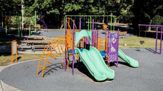 Outdoor playground at Peach Road Park for ages 2 to 5 with smaller slides