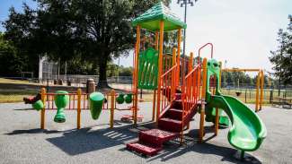 Playground structure with slide, bridge, pole, drums, steps and more