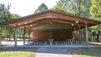 Picnic shelter at Spring Forest Road Park featuring nine picnic tables and two grills