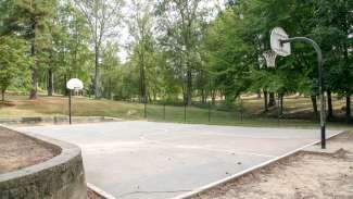 An outdoor basketball court with hoops at Worthdale Park 