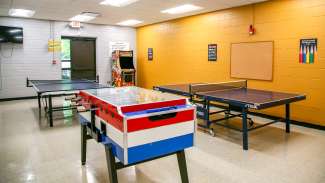 A medium sized meeting room with several games like pinball, table tennis and Foosball at Worthdale park 