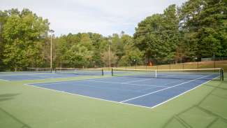 Two of six tennis courts with nets at Worthdale park 