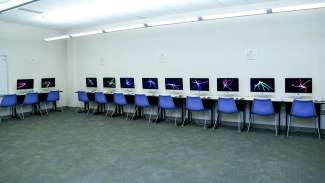 A third meeting room with a row of computers