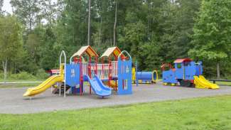 A large playground for kids with a rubber surface