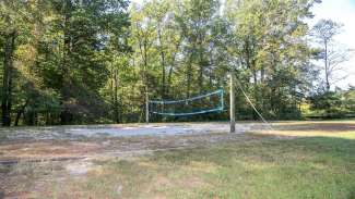 An outdoor sand volleyball court with one net 