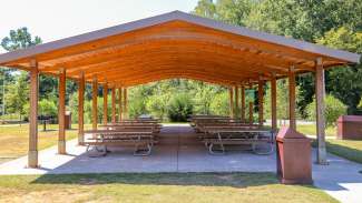A second slightly smaller picnic shelter with a dozen tables and two grills 
