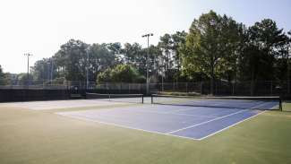 Two outdoor tennis courts with nets