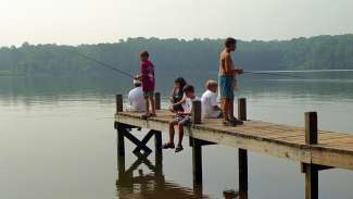 kids fishing off dock at lake wheeler