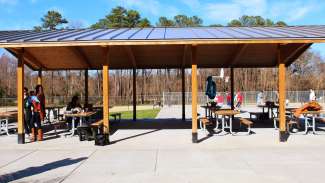 A large open picnic shelter that can accommodate up to 80 