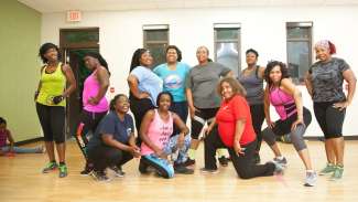 A group of ladies posing for a group picture after a zumba class