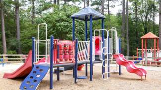 One of two playgrounds designed for younger kids with slides and climbing surface
