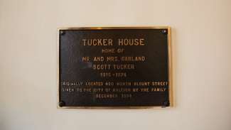 A plaque describing who lived in the Tucker House and where it used to be located