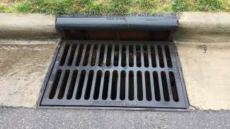 A metal storm drain on a street in Raleigh. 