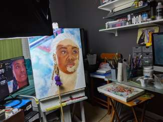 A painting on an easel in progress by Lakeshia Reed