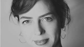 A black and white headshot of artist Alyssa Miserendino
