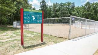 The dog park sign at Kiwanis Park with rules on it 