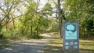 Part of the greenway and a sign with rules on it 