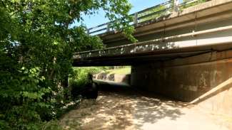concrete wall under bridge on Crabtree Creek greenway off of Glenwood Avenue