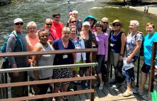 A group of active adults posing for a picture during a trip