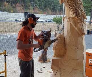 Corey Lancaster creating wood chainsaw artwork