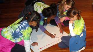 Girls working together on activity at COR Museum
